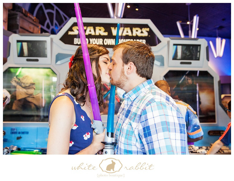 A couple smiles and embraces in front of the iconic Space Mountain ride at Disneyland.