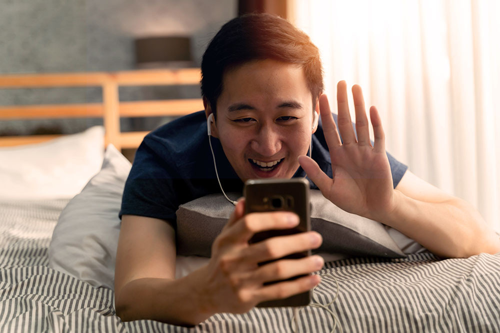 Man on the phone waving