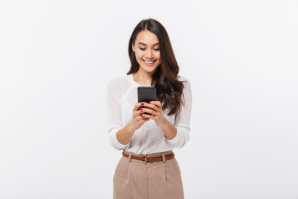 Woman smiling at her phone