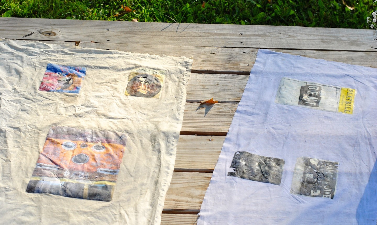 alt text: Hanging fabric with transferred images to dry.