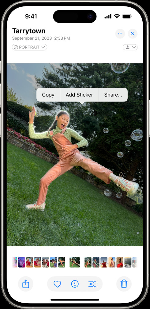 The iPhone Photos app showing a photo of a person. The person is selected, and the 'Add Sticker' option is highlighted in the menu.