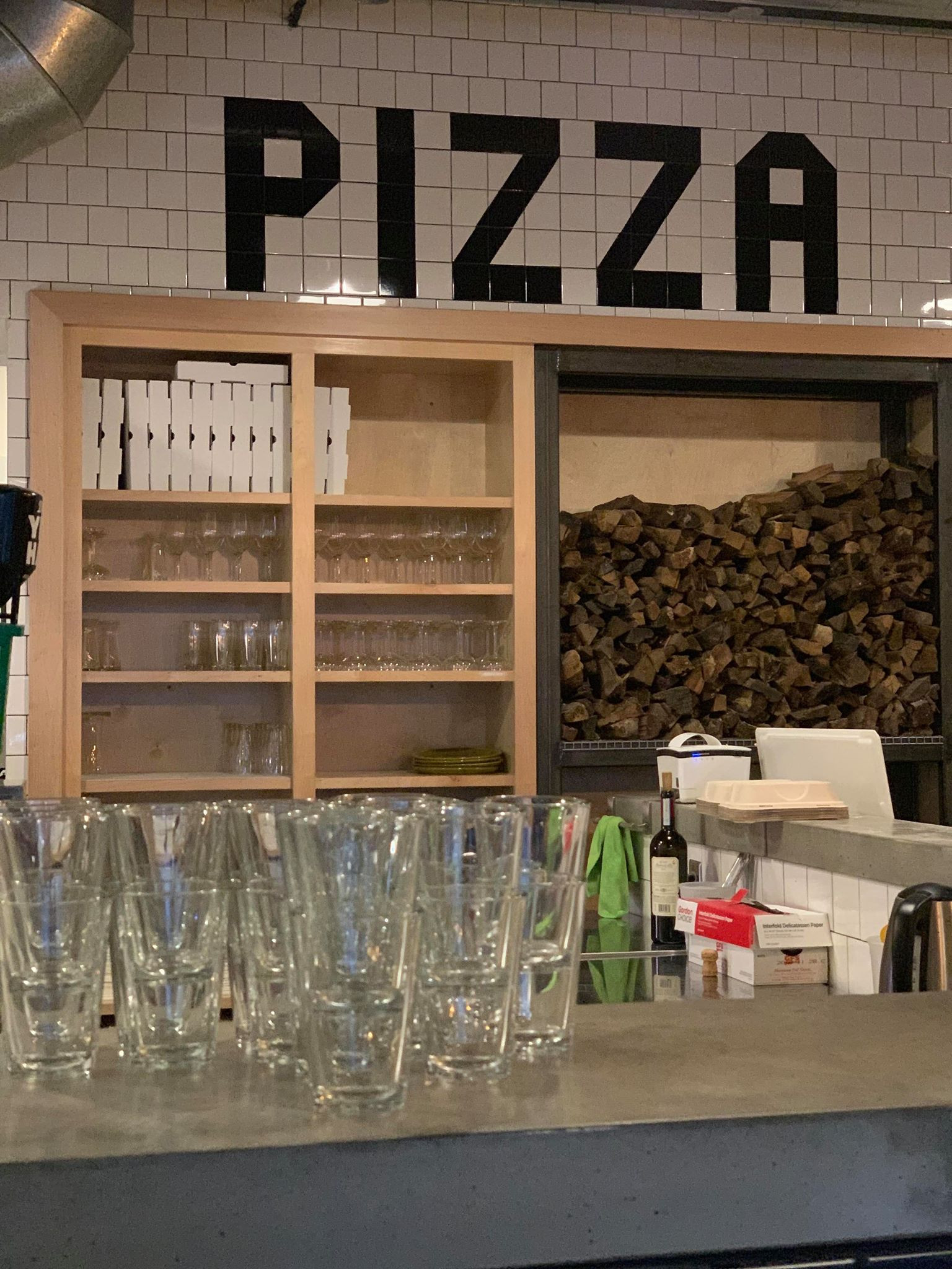 Interior view of A Dopo Sourdough Pizza showcasing the pizza oven and dining area