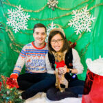 A woman standing in front of a DIY Christmas photo backdrop