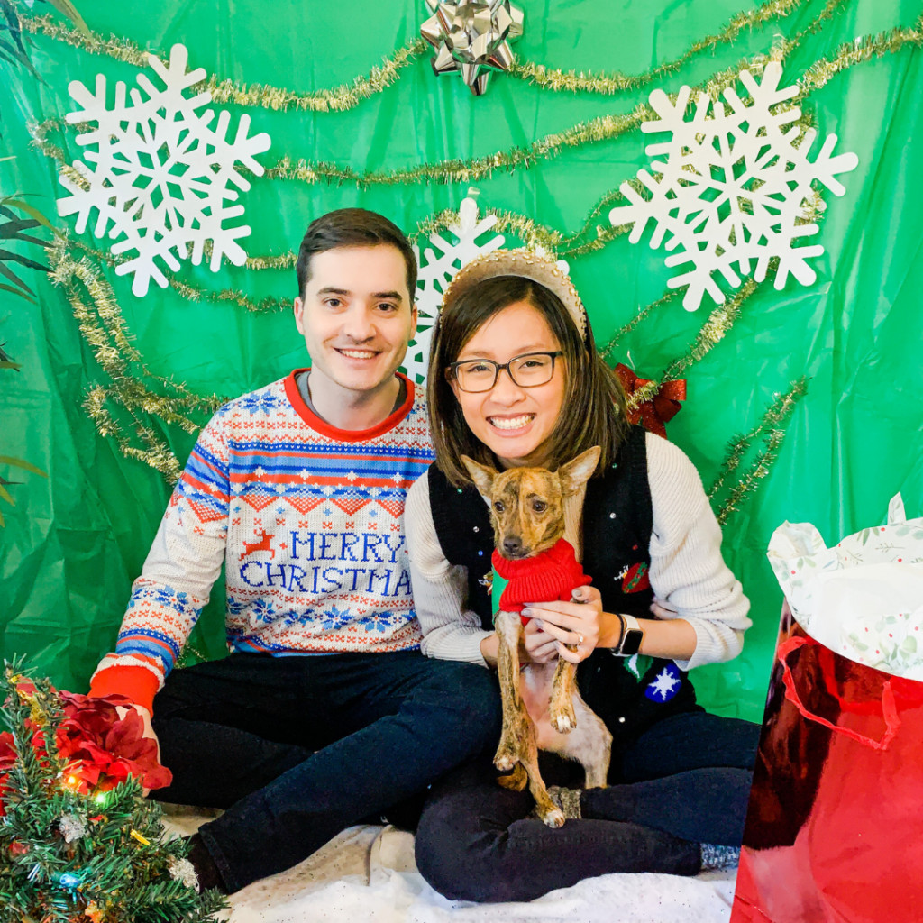 A woman standing in front of a DIY Christmas photo backdrop