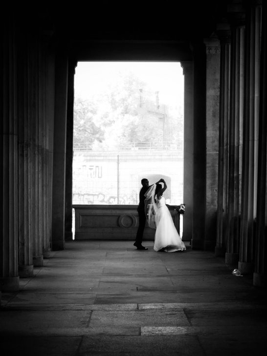 Black and white photograph of a solitary figure in an urban environment, emphasizing simplicity and isolation