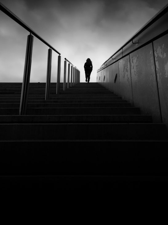 Close-up silhouette of a person's profile against a bright background, emphasizing shape over detail