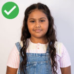 correct passport photo of a child facing the camera directly