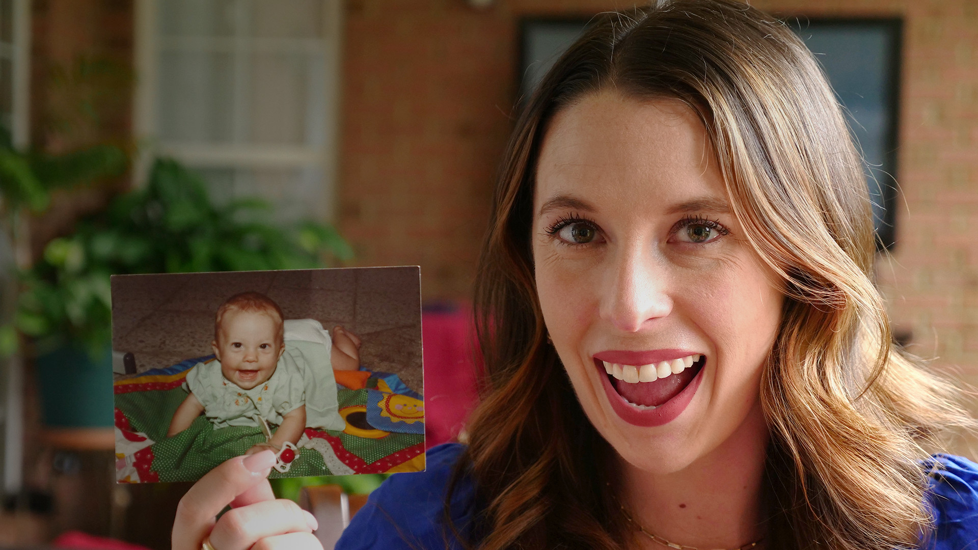 alt text: Woman holding a box of old photos