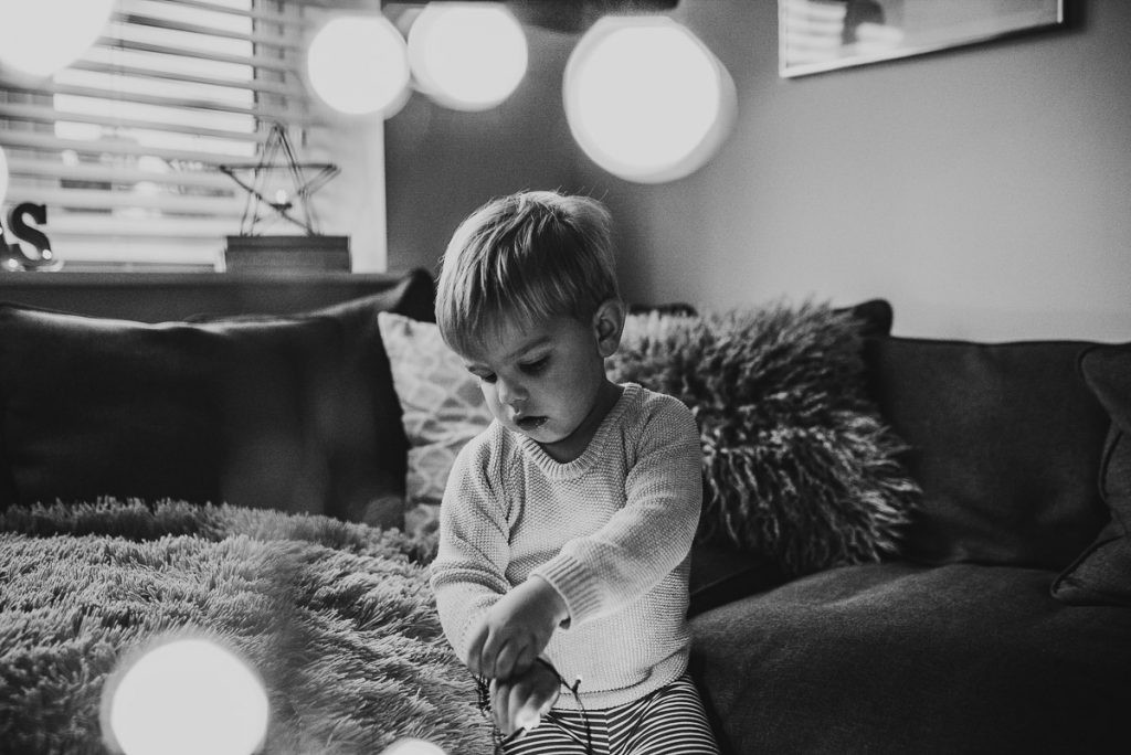 A child is pictured in a festive Christmas setting, emphasizing the importance of creative and varied shots for DIY Christmas photos.