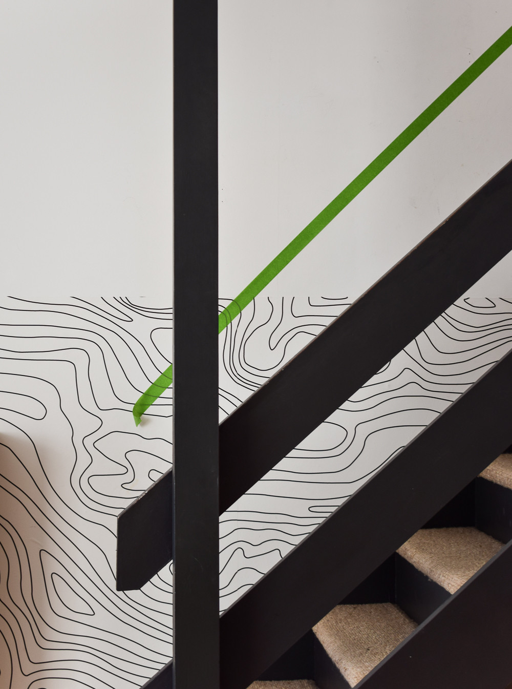 Painter's tape template used to create a stepped arrangement for a staircase gallery wall