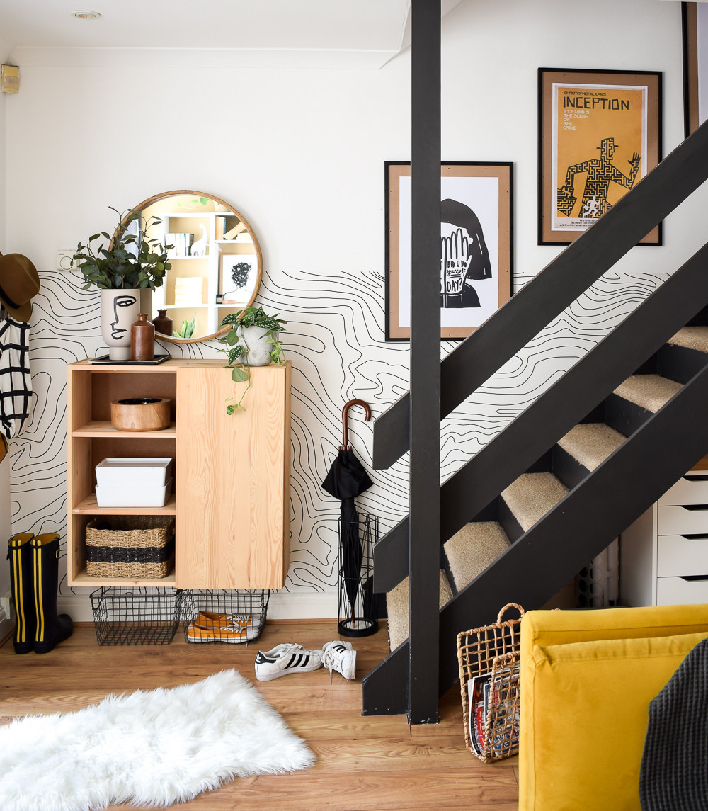 Final staircase gallery wall with a mix of frame styles and artwork, creating a stylish living room feature