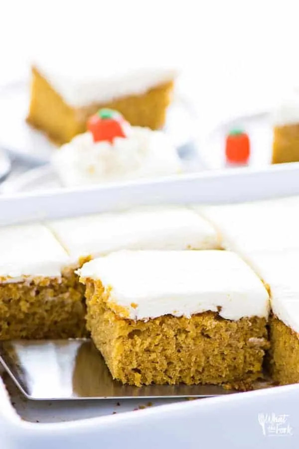 A close-up shot of a frosted gluten-free pumpkin cake, highlighting its moist texture.