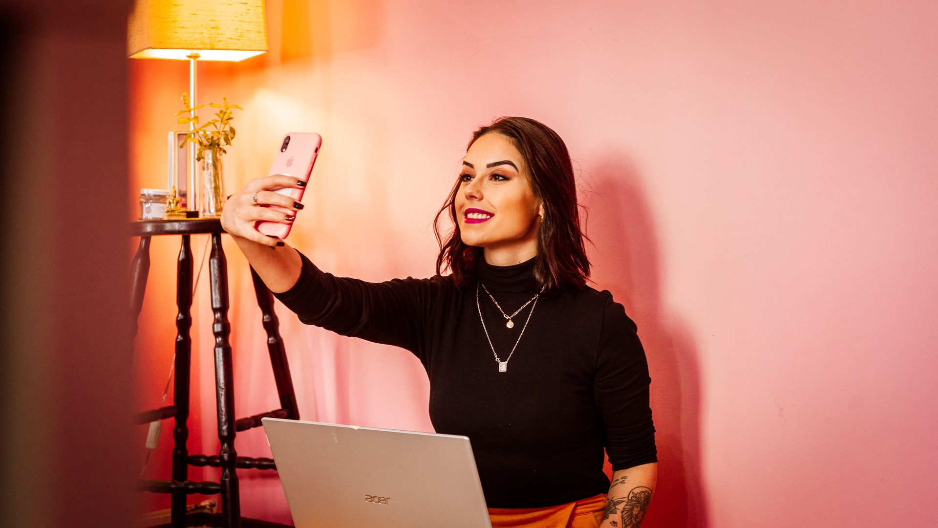 person taking a selfie with smartphone, how to take photos of yourself with your phone