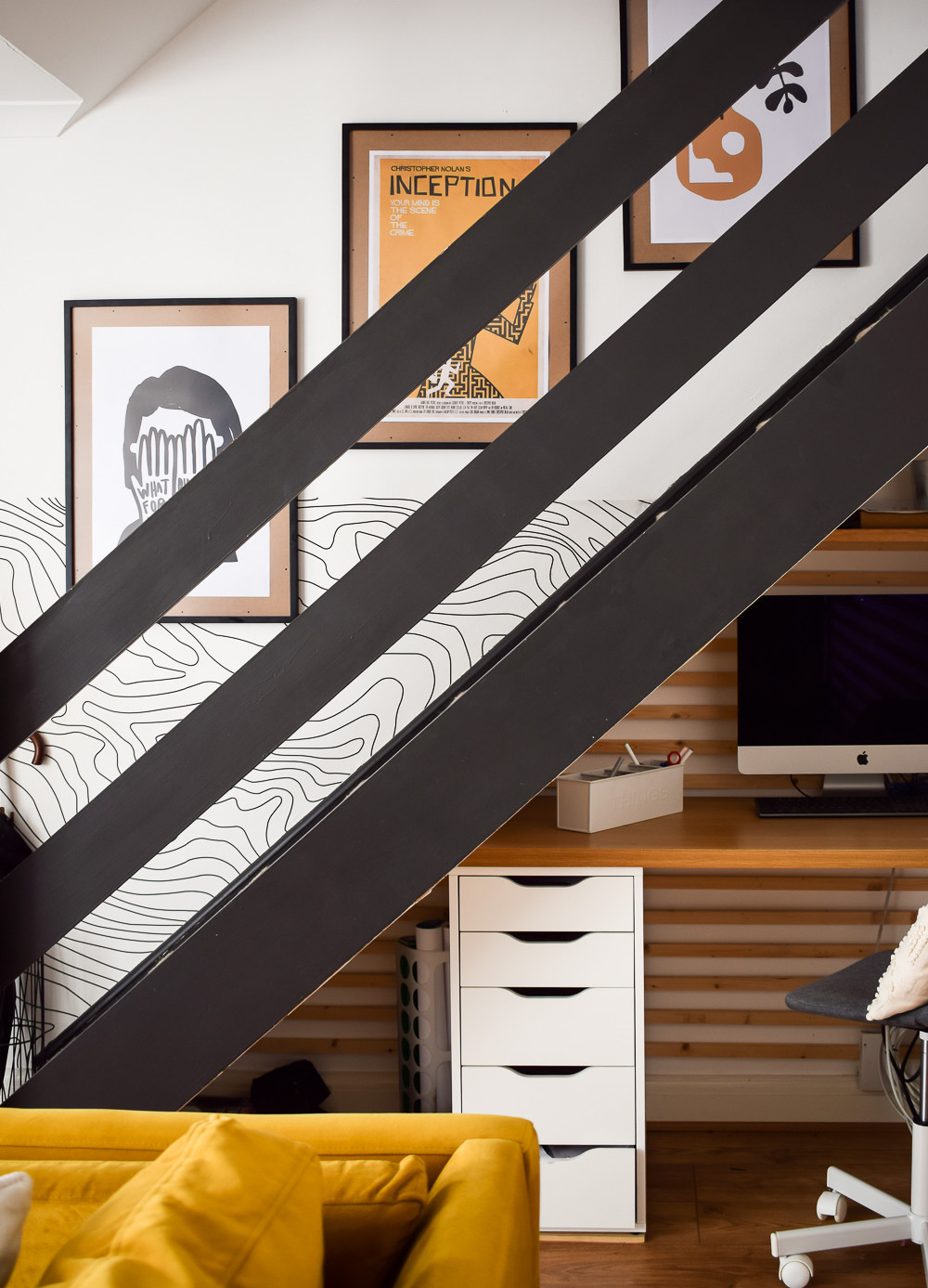 Stepped arrangement of three picture frames along a staircase wall, showcasing a simple yet effective gallery wall style