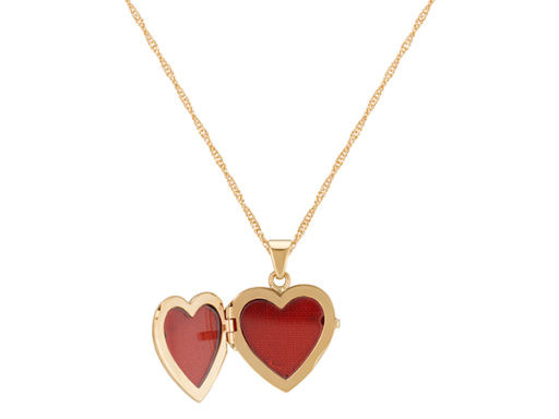 A hand holding a printed photo next to an open locket, showing the comparison between photo size and locket frame size, highlighting the need for correct dimensions