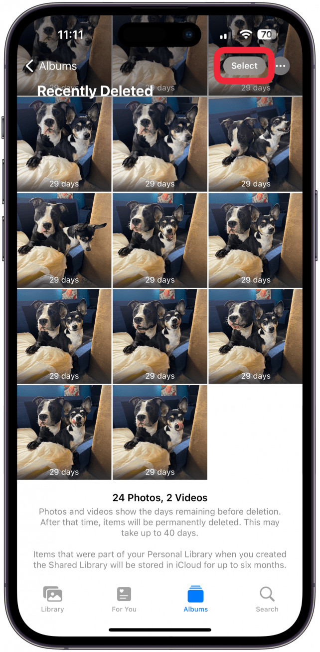 Tapping the select button in the top right corner of the iPhone Photos app, preparing to delete multiple photos.