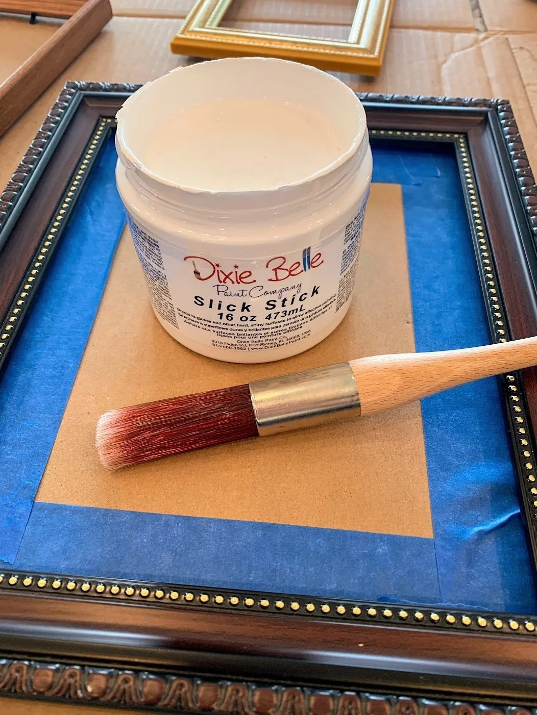 Applying primer to a picture frame.