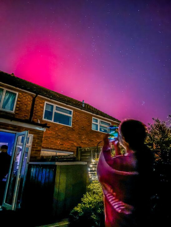 Close up of iPhone screen showing focus and exposure adjustments for aurora photography