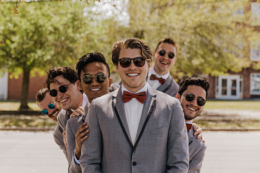 Groom and groomsmen dancing energetically at Wilmington NC wedding reception