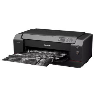 Canon ImagePrograf Pro-1100 printer, with a black-and-white print in its tray, against a white background