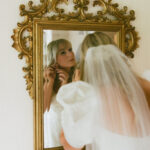 Bride looking into mirror