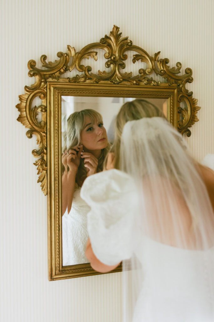 Bride looking into mirror