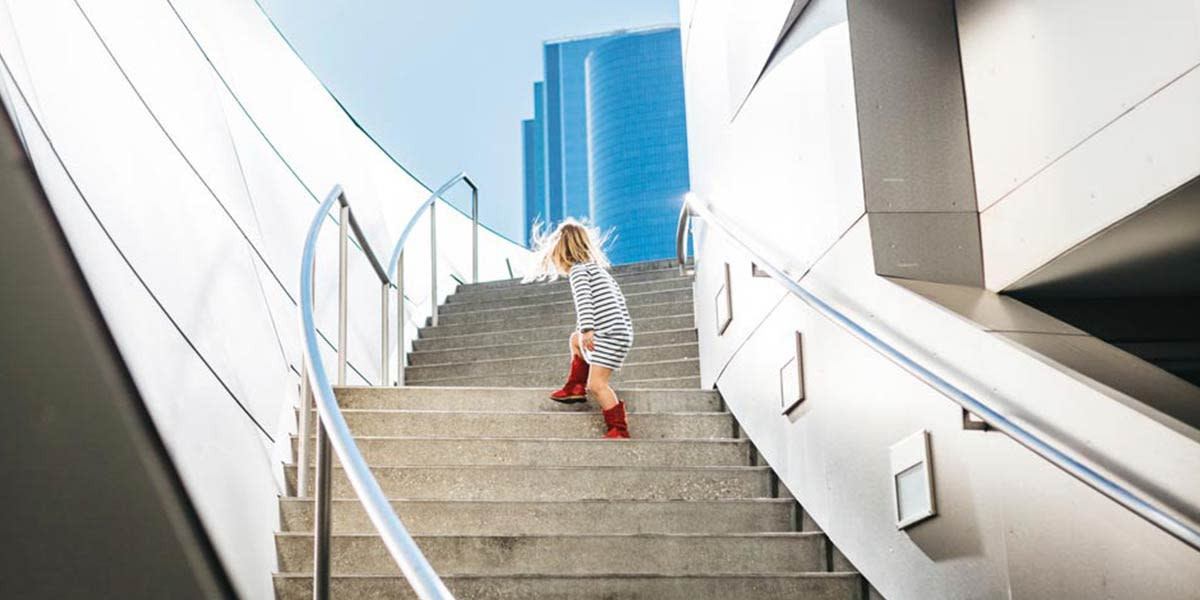 A young girl ascending stairs, positioned according to the rule of thirds, demonstrates balanced composition in photography.