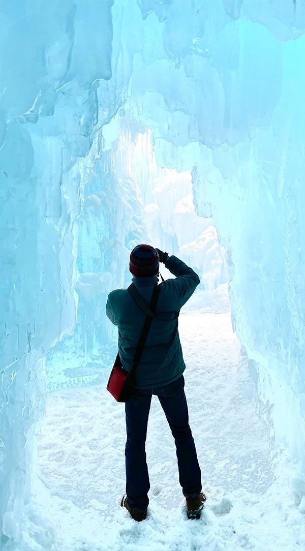 Professionally edited photo of a photographer in an ice cave, frame selected from Live Photo