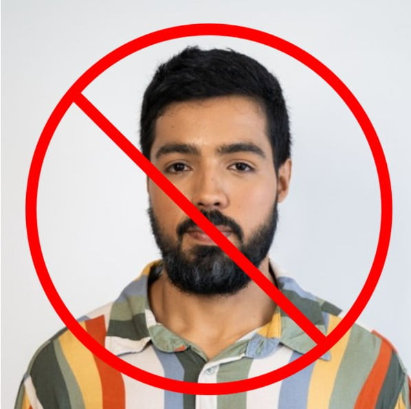 a passport photo of a man in a shirt with a loud pattern