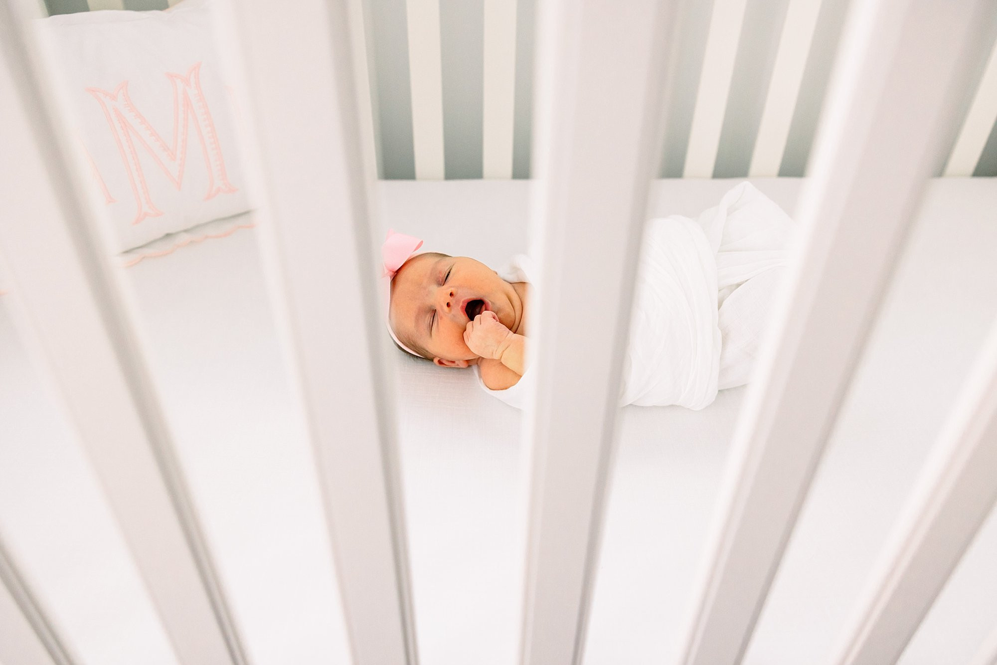 alt text: Edited newborn photo of baby wrapped in blanket.