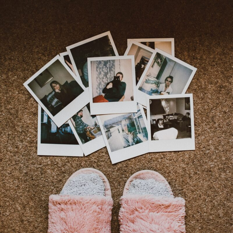 A woman holding a Polaroid photo