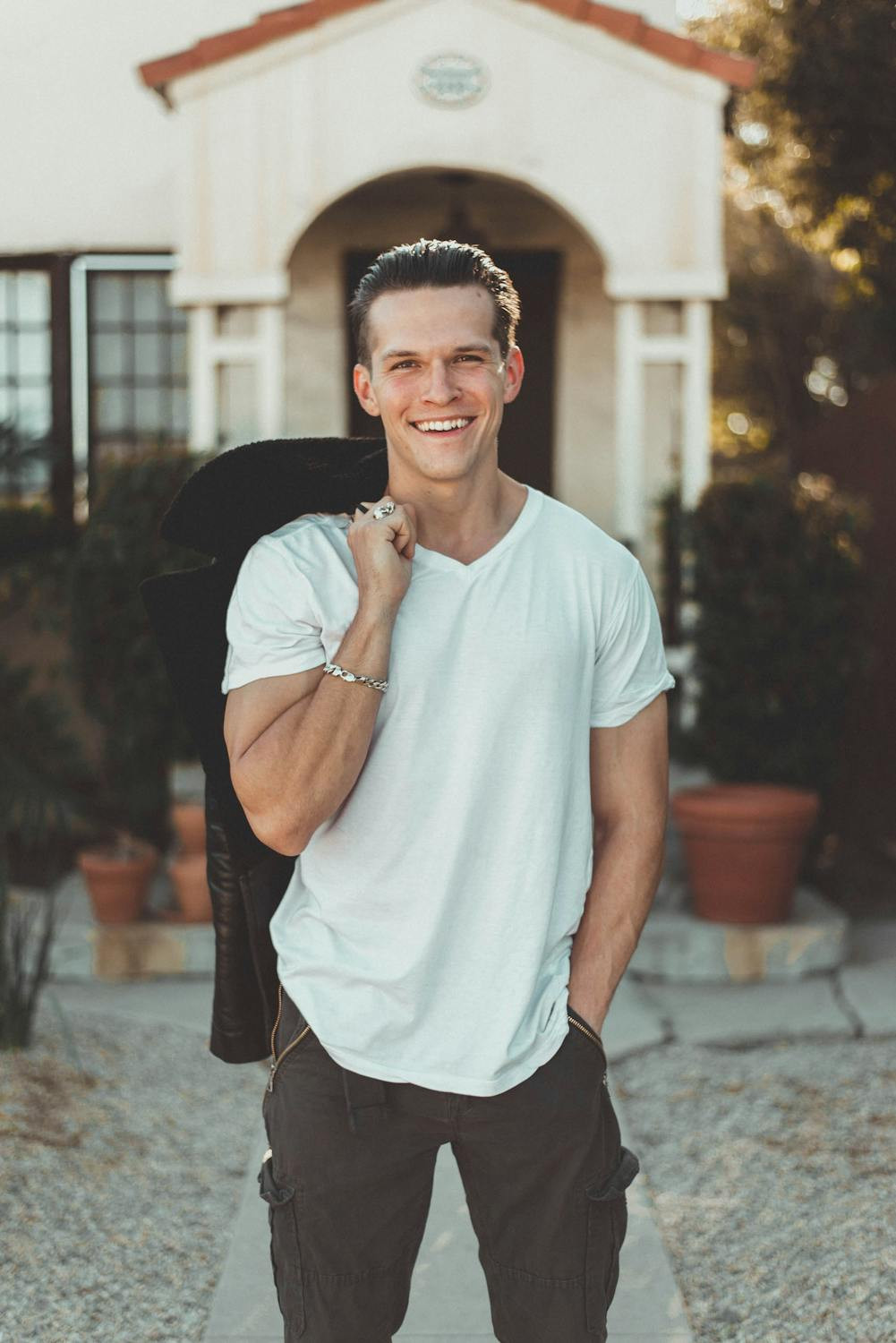 Person smiling for a profile photo in a well-lit outdoor setting