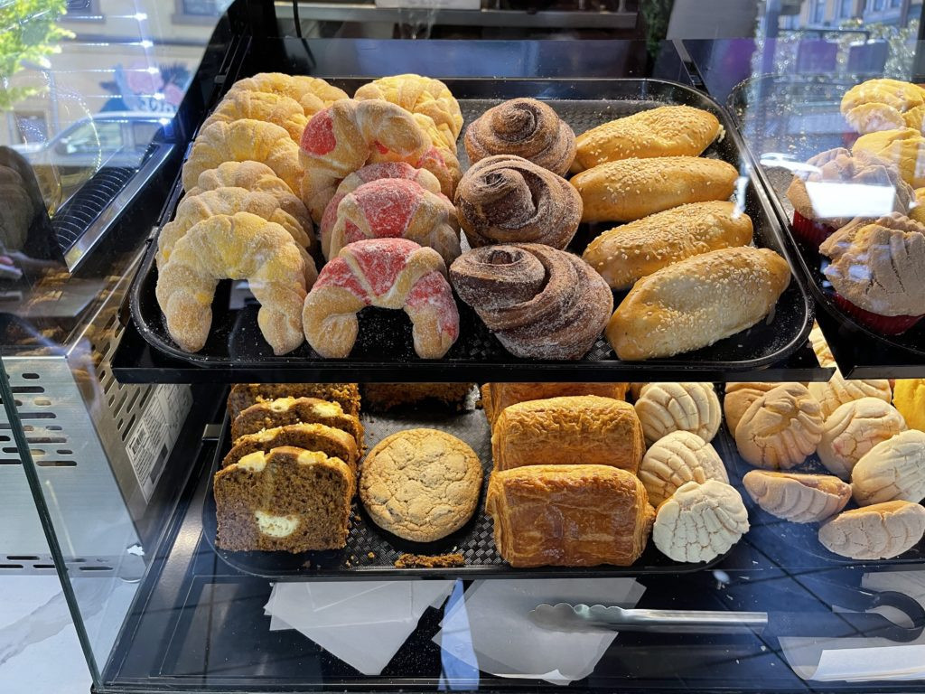 Display of pan dulce at Con Azucar Café showcasing variety and freshness