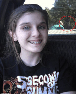 A photo of a woman with Beyonce and Jay-Z in the background.