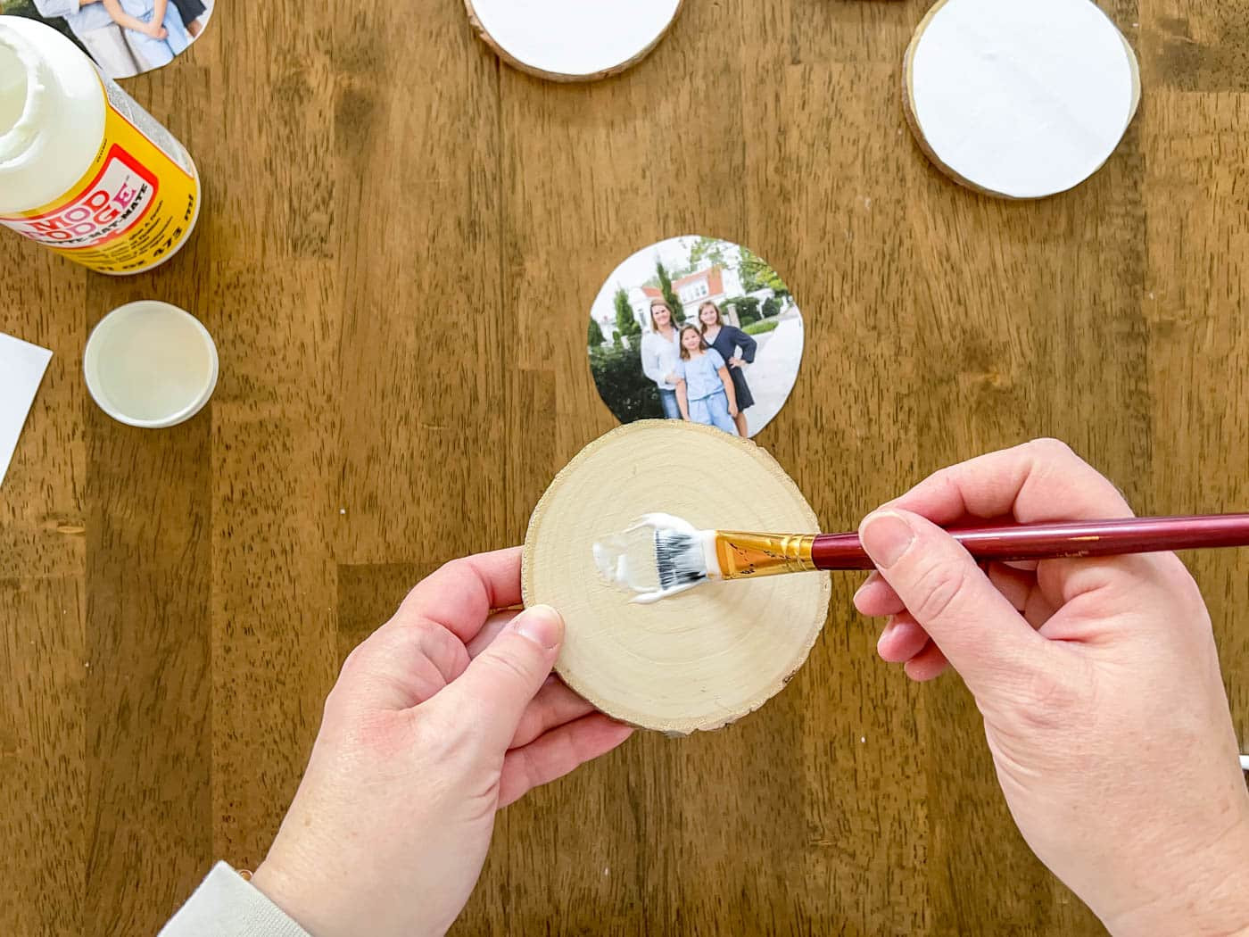 Paint a layer of Mod Podge on the wood slice