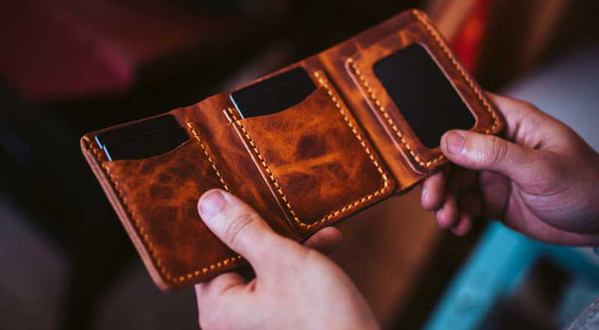 Hand holding the Trifold Leather Wallet