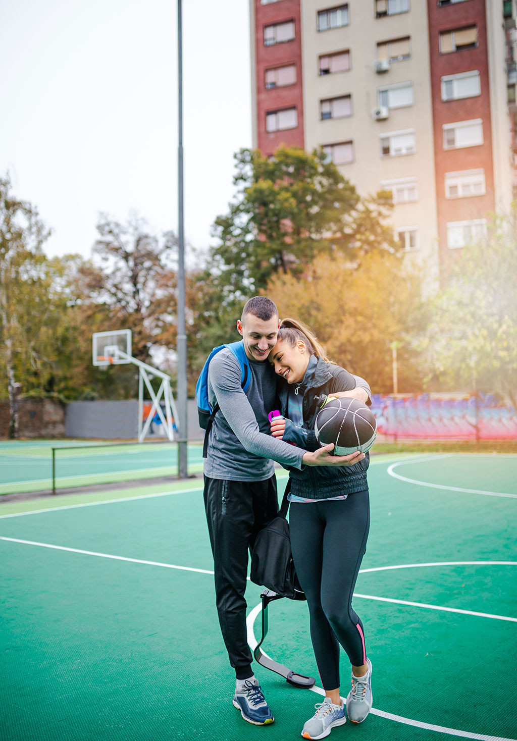 Close-up of a couple playing basketball, emphasizing relationships in stock photos