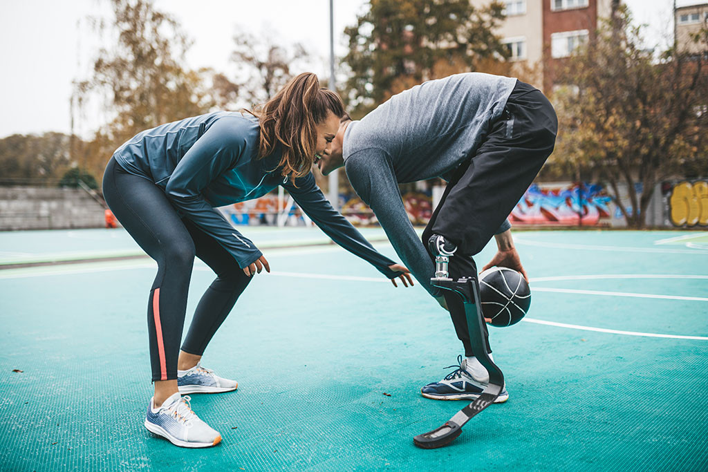 Couple playing basketball, showcasing active lifestyle in inclusive stock photography