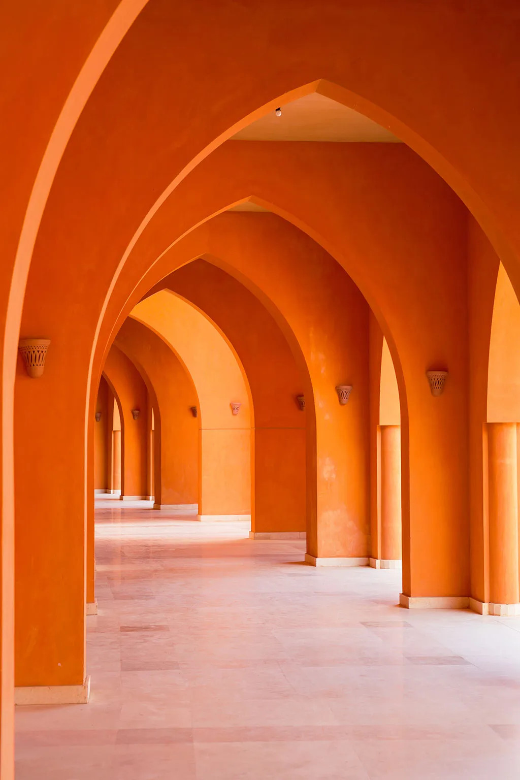Architectural archway in orange tones, featuring property-released architecture in stock photography