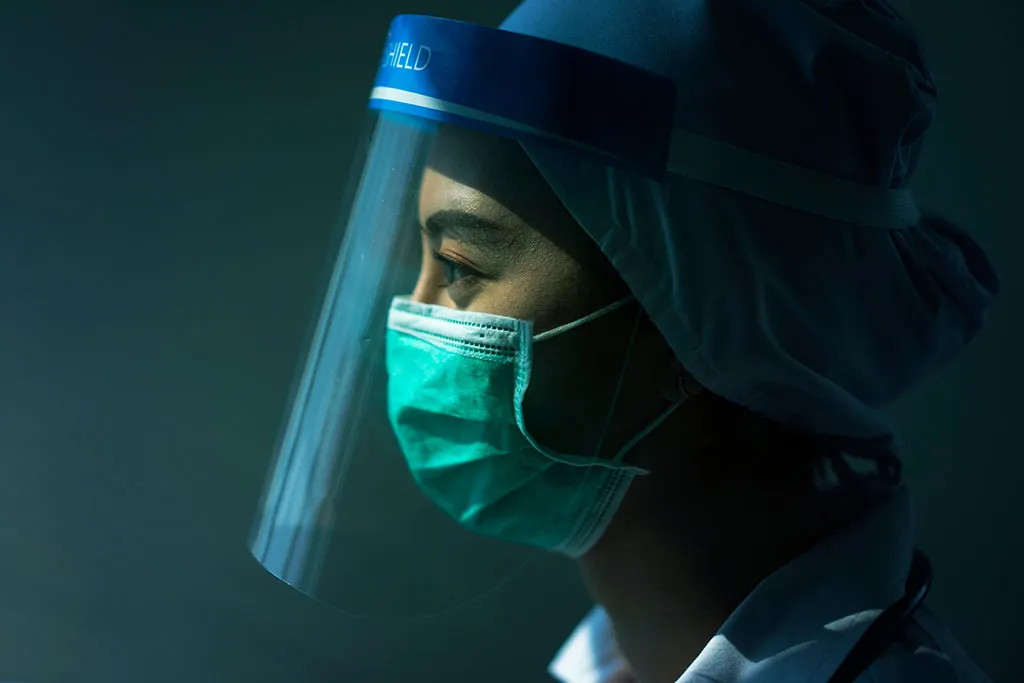 Portrait of a nurse wearing a mask, representing essential workers in stock photography