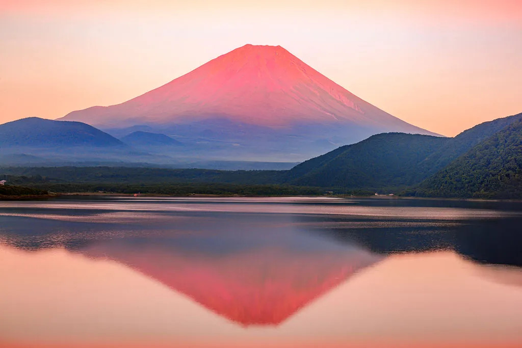 Scenic sunset over a lake and mountain range, inspiring travel and outdoor adventures in stock photos