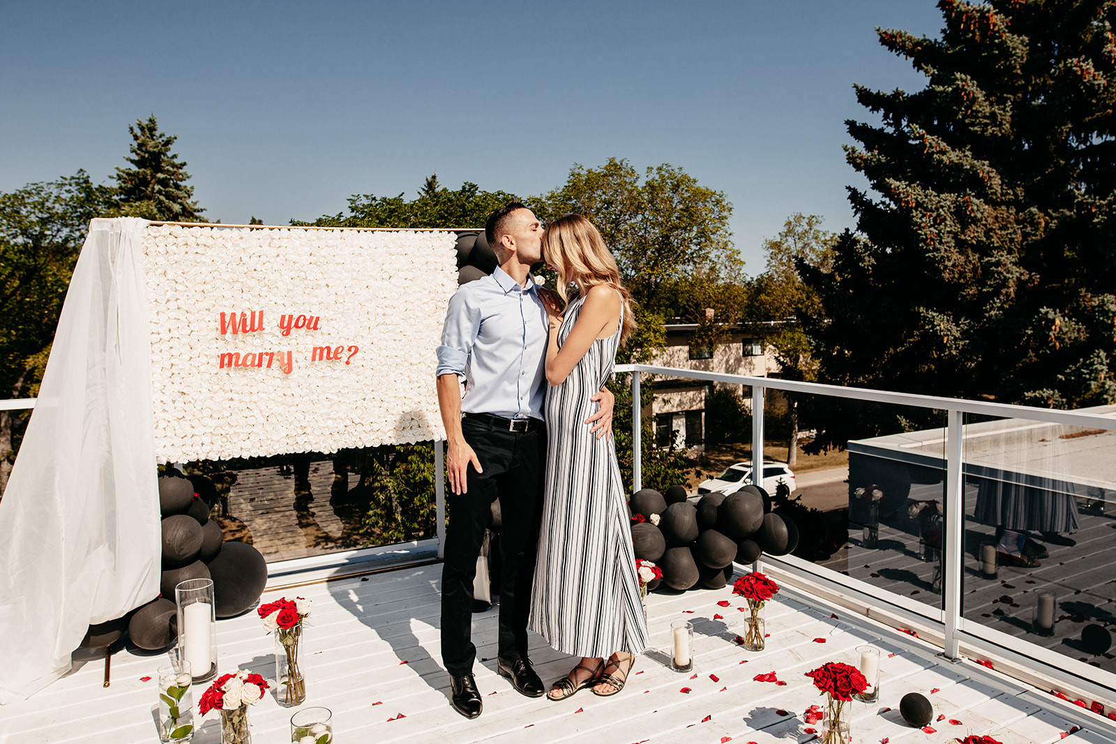 Man holding &quot;Will You Marry Me&quot; sign, emphasizing the proposal and immediate engagement photos