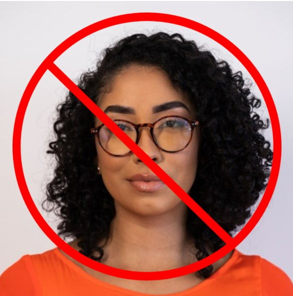 a woman wearing glasses in a passport photo that will be rejected