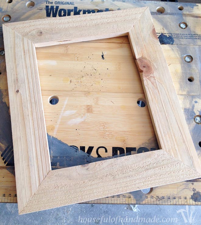 A completed DIY wood frame before painting, ready for the finishing touches to enhance its rustic appeal.