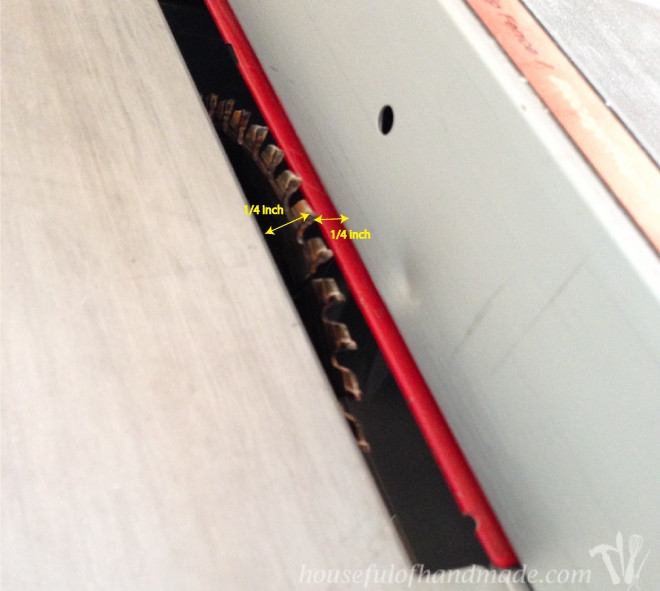Close-up of wood being cut with a table saw, demonstrating the process of creating grooves for DIY rustic picture frames.