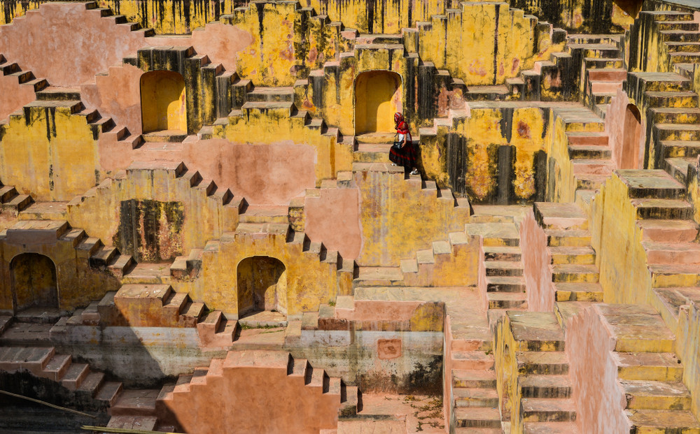 Woman in traditional Indian dress visiting ancient temple