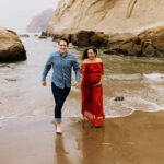 Pregnant woman in red lace textured dress during maternity photos