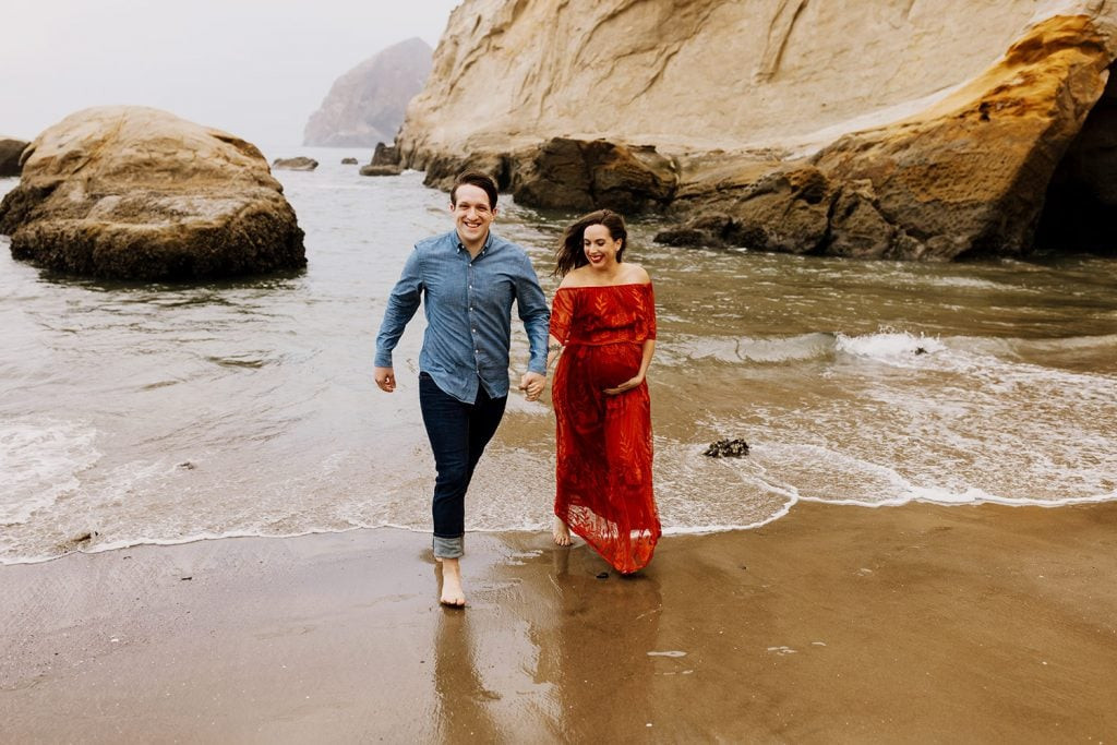 Pregnant woman in red lace textured dress during maternity photos