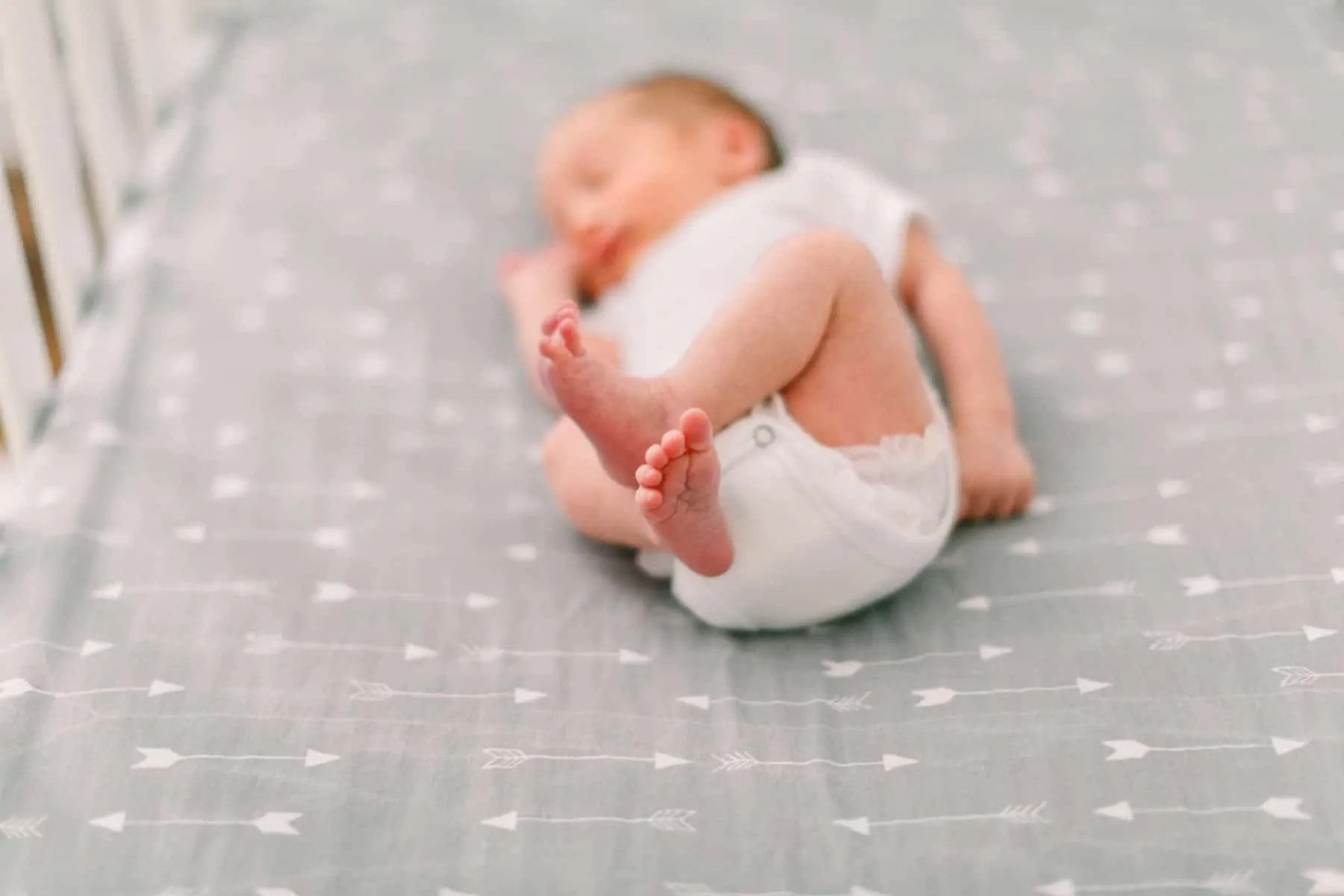 alt text: Close up of baby's feet in crib.