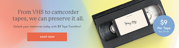 Alt text: A woman holding a Legacybox filled with old photos and VHS tapes.